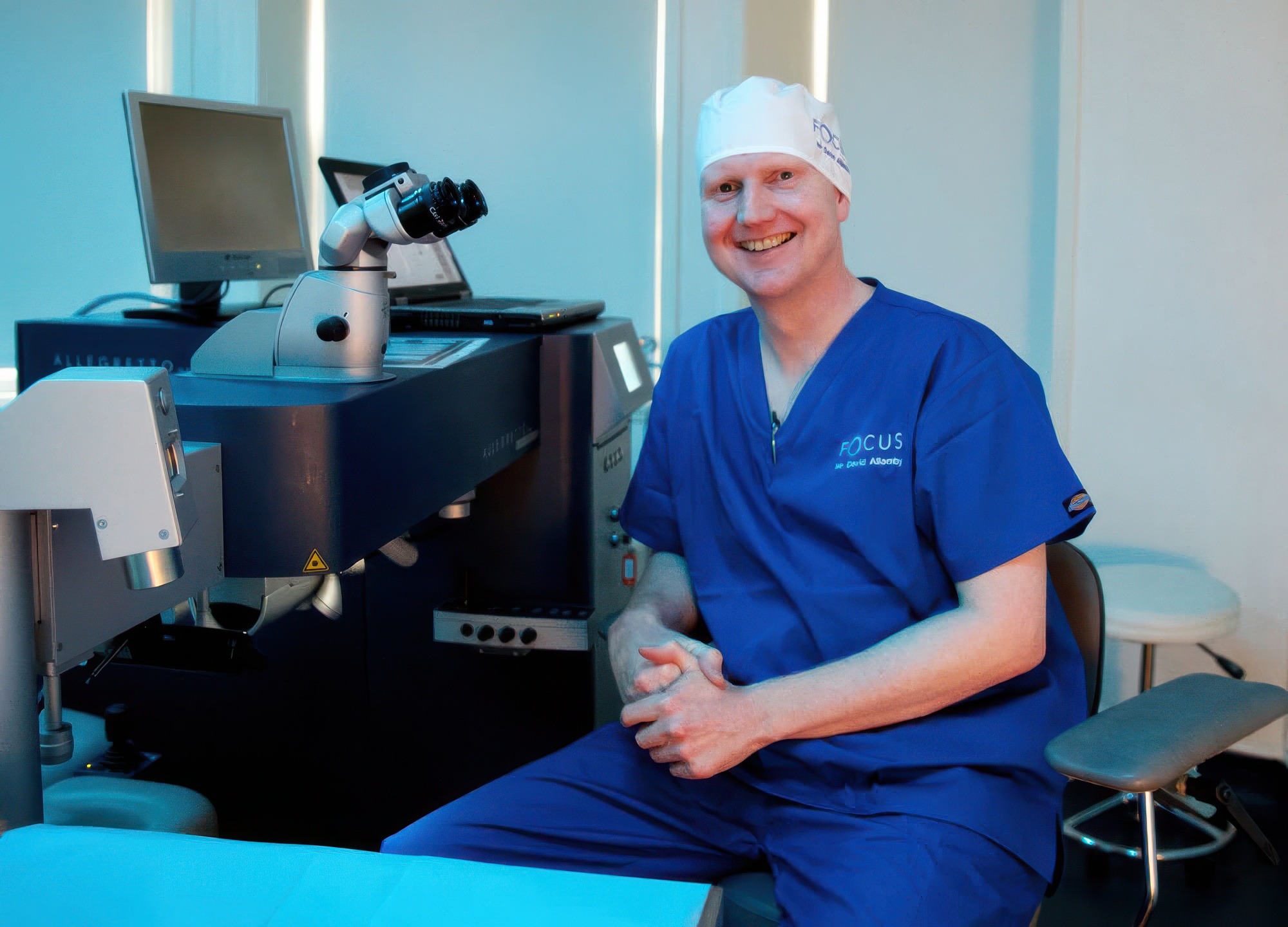 Focus Clinics surgeon David Allamby beside the laser eye surgery system